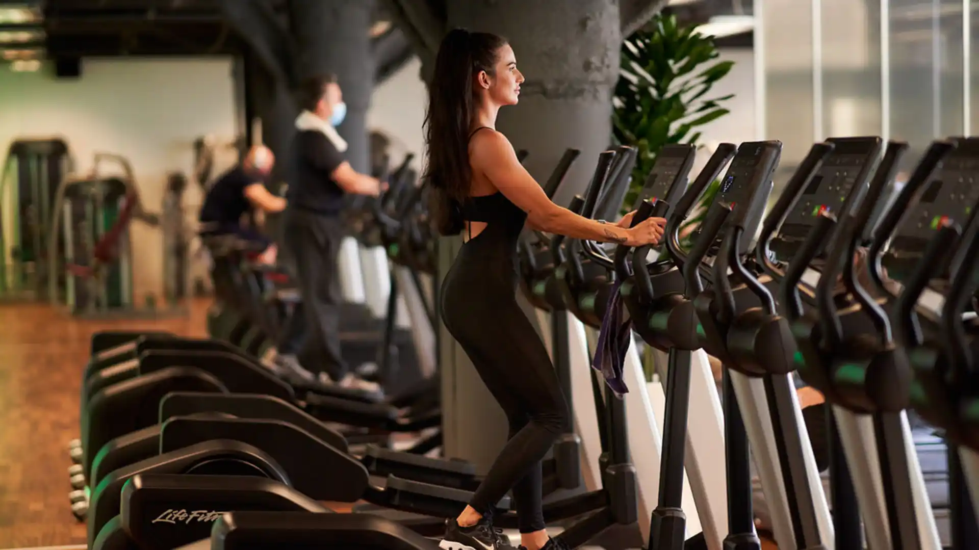 Persona entrenando en una elíptica en AltaFit Torre Picasso